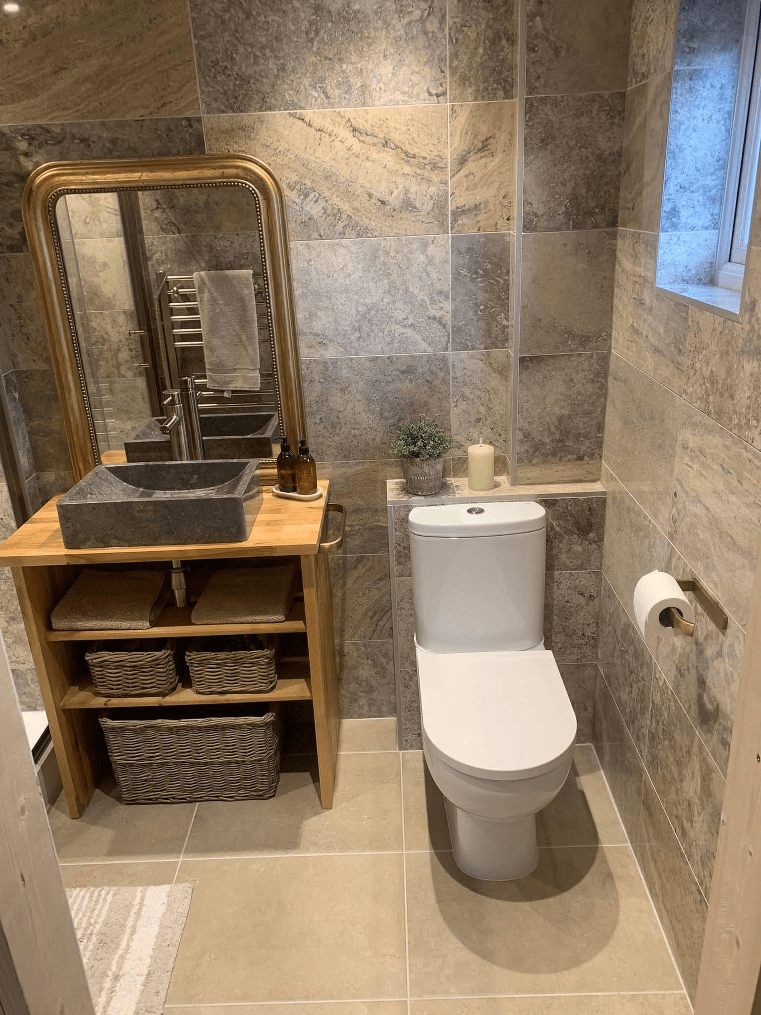 Cloakroom with natural stone tiles and oak vanity unit - bathroom fitter West Sussex