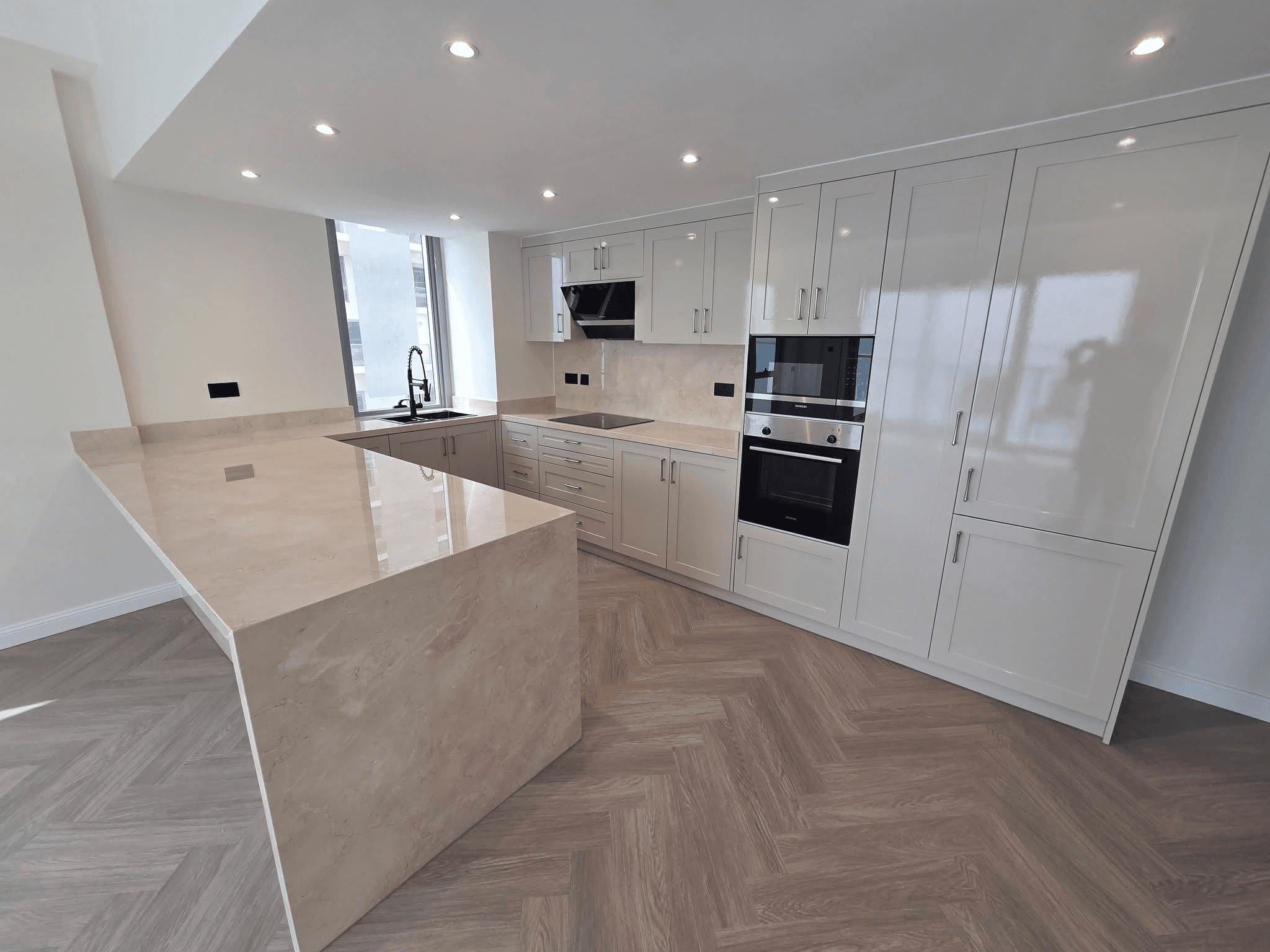 New kitchen installation with island and herringbone flooring - kitchen fitter Littlehampton